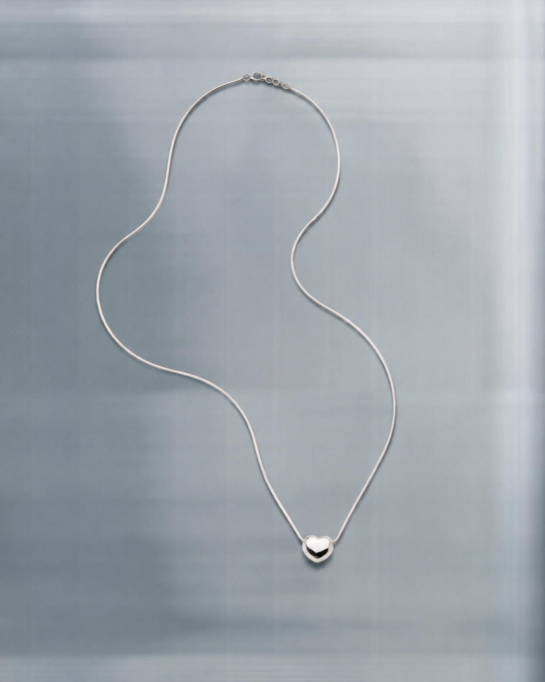 A waterproof necklace on a plain background